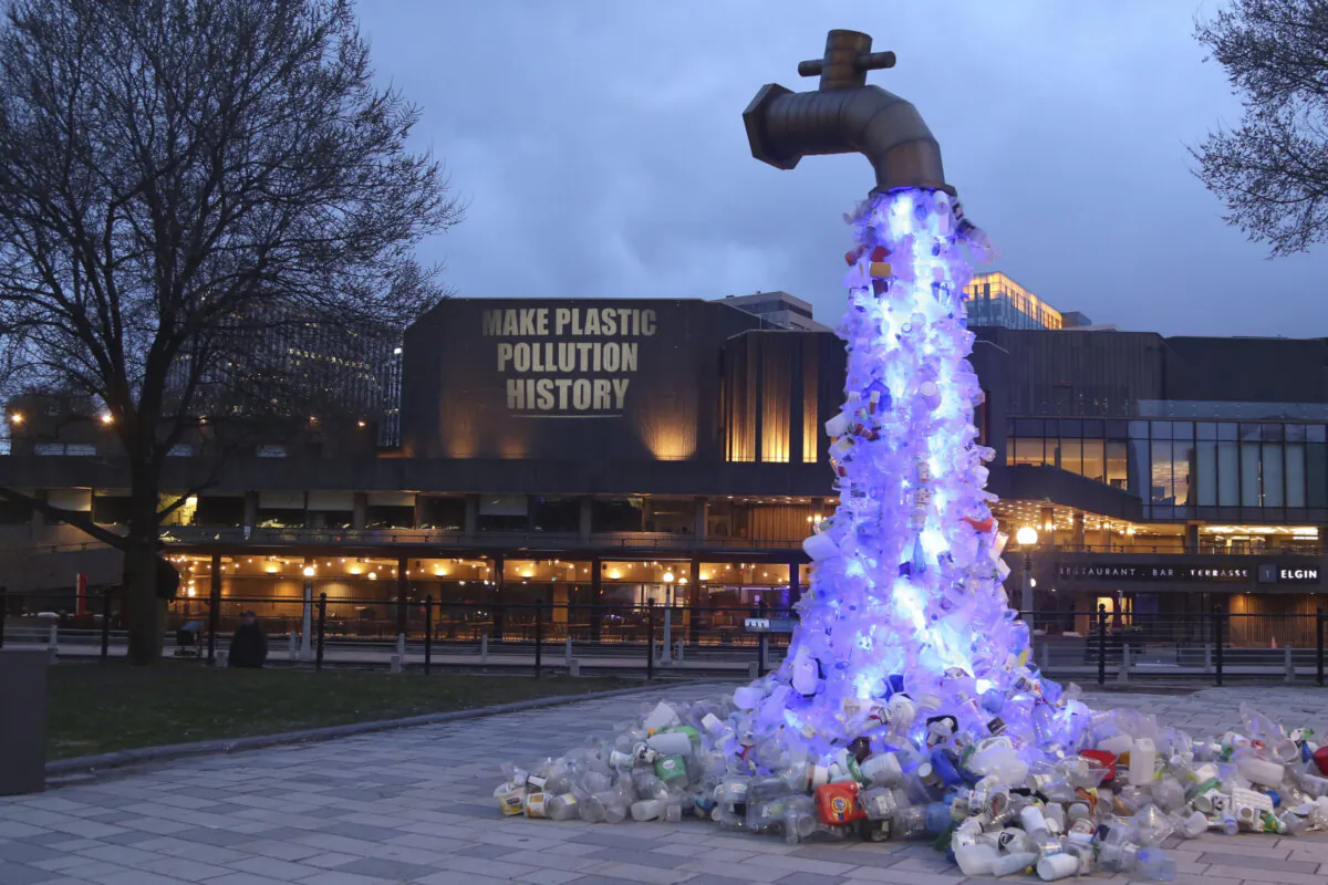 “Make Plastic Pollution History” is projected onto the National Arts Centre in Ottawa by activist organizations on April 21, 2024. (Canadian Press Images/Oceana Canada and EarthDay.Org)