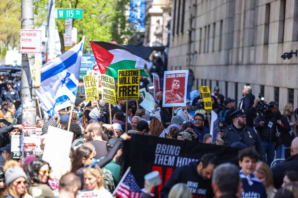Pro-Palestinian and pro-Israel face off in front of the entrance of Columbia University which is occupied by pro-Palestinian protesters in New York on April 22, 2024. (Charly Triballeau/AFP via Getty Images)
