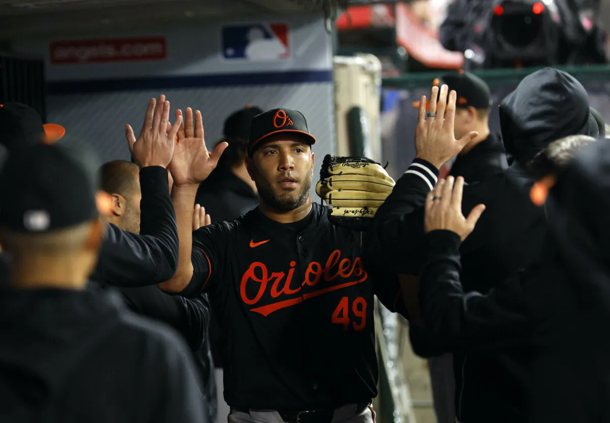 Starting pitcher Albert Suárez #49 of the Baltimore Orioles slaps hands with teammates after coning out of the game in the sixth inning against the Los Angeles Angels at Angel Stadium of Anaheim on April 22, 2024. (Kevork Djansezian/Getty Images)