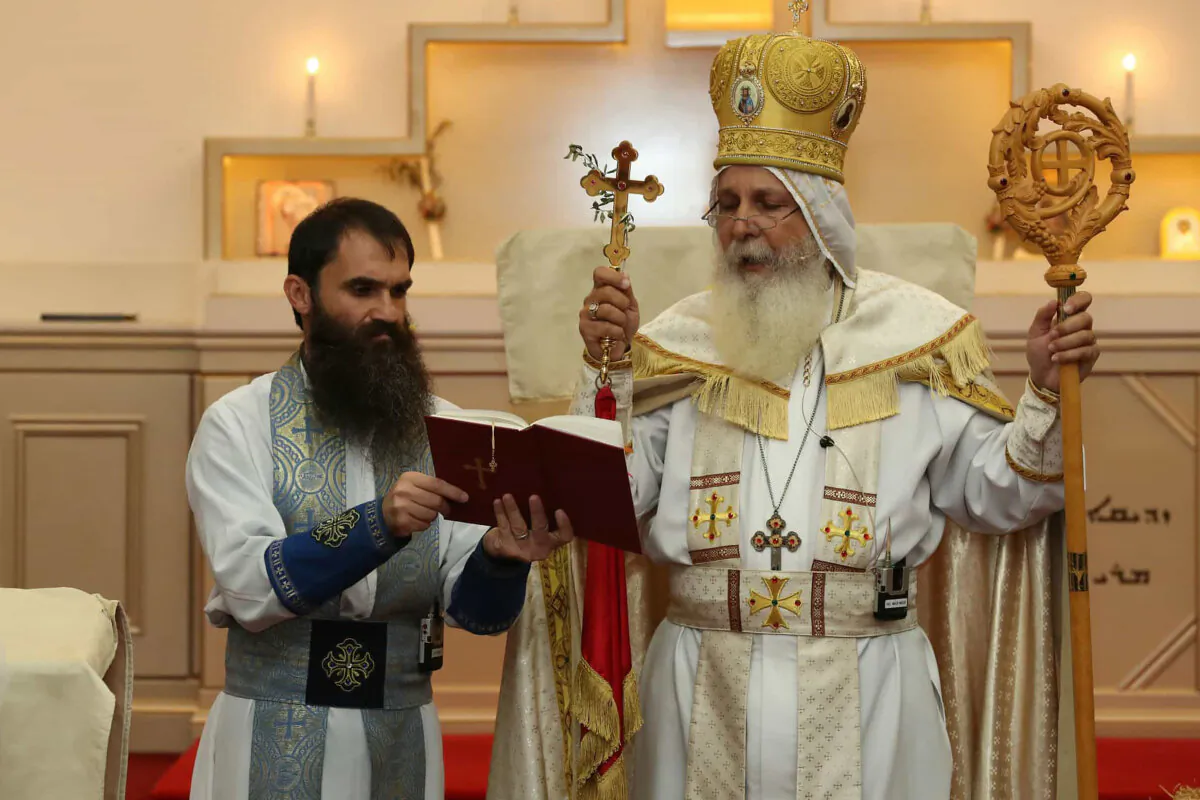 A supplied image obtained on Tuesday, April 16, 2024, shows Senior Parish Priest Fr. Isaac Royel (left) and Bishop Mar Mari Emmanuel during the 2023 Holy Resurrection Feast services. A knife attack at a western Sydney church has been deemed a terrorist act, granting NSW Police expanded powers to act without a warrant. (AAP Image/Supplied by Christ The Good Shepherd Church) NO ARCHIVING, EDITORIAL USE ONLY