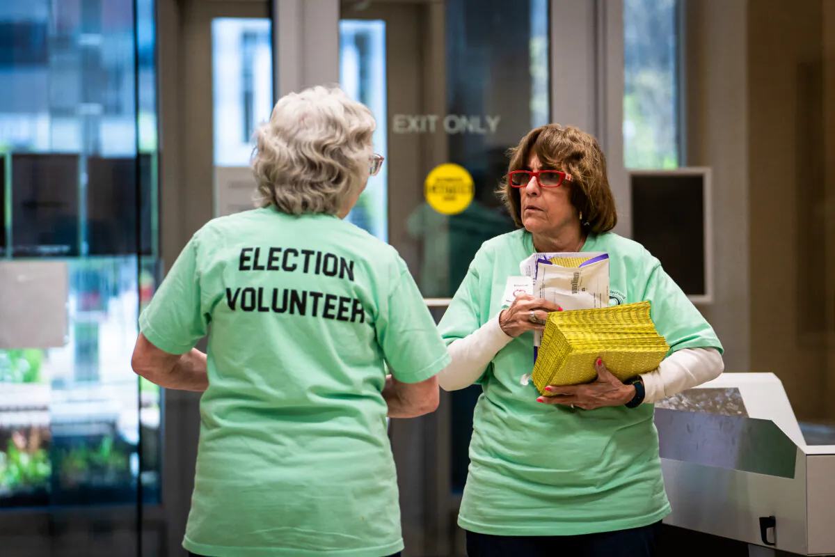 Election workers prepare mail-in ballots for scanning at the Lancaster County Government Center in Lancaster, Pa., on April 23, 2024. (Madalina Vasiliu/The Epoch Times)