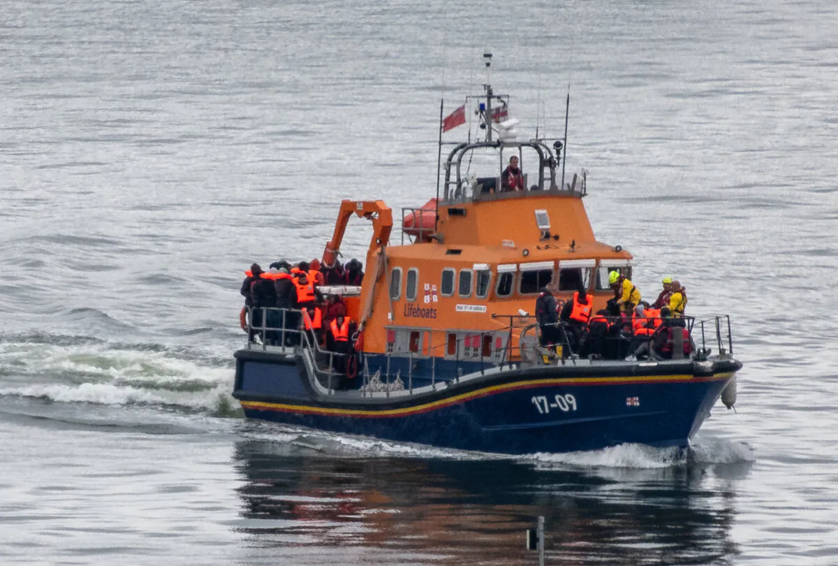 Migrants are brought into Dover Port by an RNLI lifeboat after being picked up in the English Channel while trying to make the journey from France in inflatable dinghies, in Dover, England, on April 23, 2024. (Chris J Ratcliffe/Getty Images)