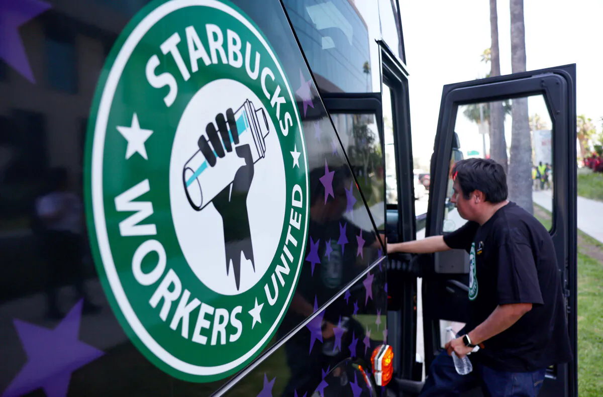 A Starbucks worker boards the Starbucks union bus after workers stood on the picket line with striking actors and writers outside Netflix studios in Los Angeles on July 28, 2023. (Mario Tama/Getty Images)