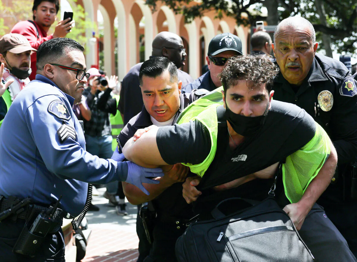 USC public safety officers detain a pro-Palestine demonstrator during clashes after officers attempted to take down an encampment in support of Gaza at the University of Southern California in Los Angeles on April 24, 2024. (Mario Tama/Getty Images)