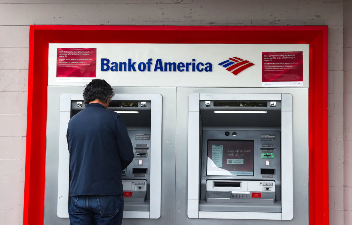 A Bank of America customer uses an ATM at a Bank of America branch office in San Francisco, Calif., on July 14, 2021. (Justin Sullivan/Getty Images)