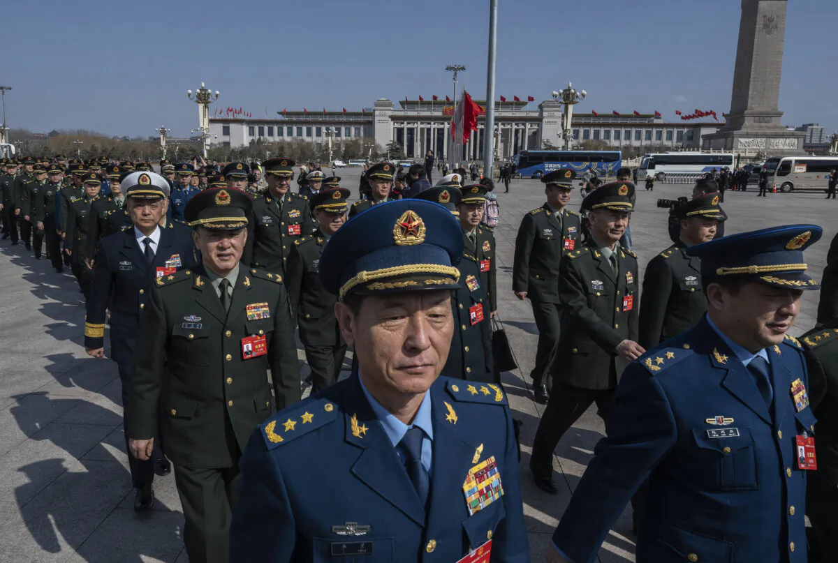 Military delegates walk together as they arrive at the closing session of the NPC, or National Peoples Congress at the Great Hall of the People on March 11, 2024 in Beijing, China. (Kevin Frayer/Getty Images)