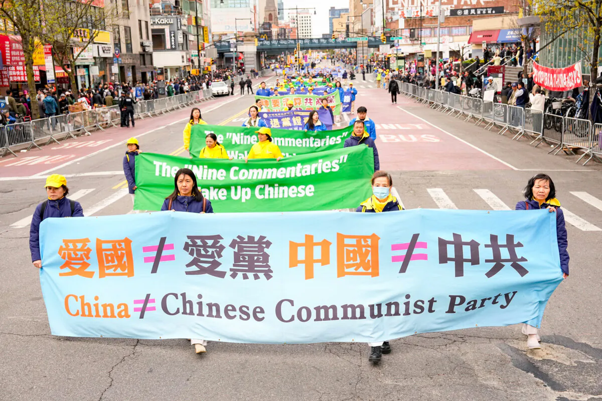 Falun Gong practitioners attend a parade to call for an end to the persecution in China of their faith, in the Flushing neighborhood of Queens, New York, on April 21, 2024. (Larry Dye/The Epoch Times)