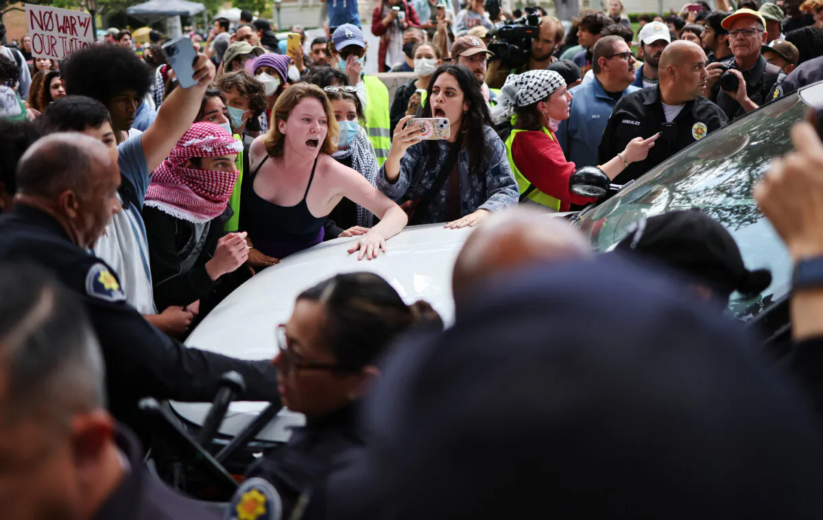 Pro-Palestine demonstrators argue with USC public safety officers after officers attempted to take down an encampment in support of Gaza at the University of Southern California in Los Angeles on April 24, 2024. (Mario Tama/Getty Images)