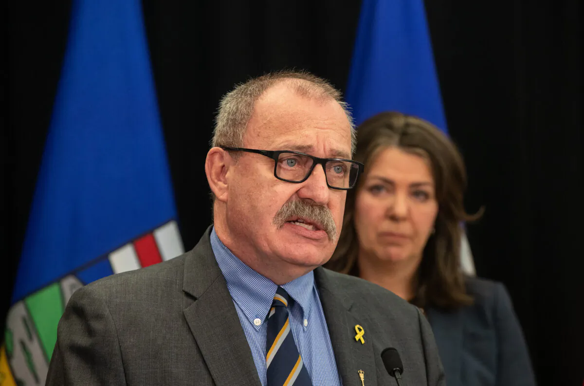 Minister of Municipal Affairs Ric McIver and Alberta Premier Danielle Smith introduce legislation addressing agreements between the federal government and provincial entities in Edmonton on April 10, 2024. (The Canadian Press/Jason Franson)