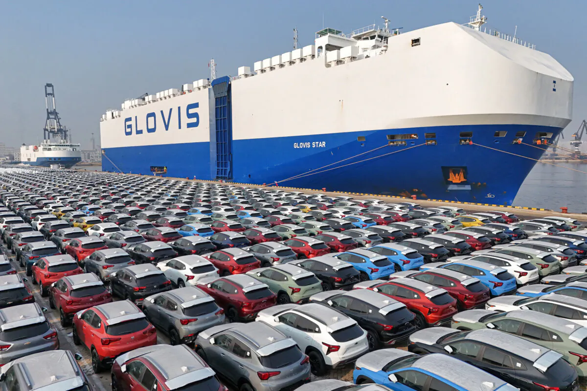 Cars wait to be loaded onto a ship for export at the port in Yantai, in China's eastern Shandong Province, on Jan. 2, 2024. (STR/AFP via Getty Images)