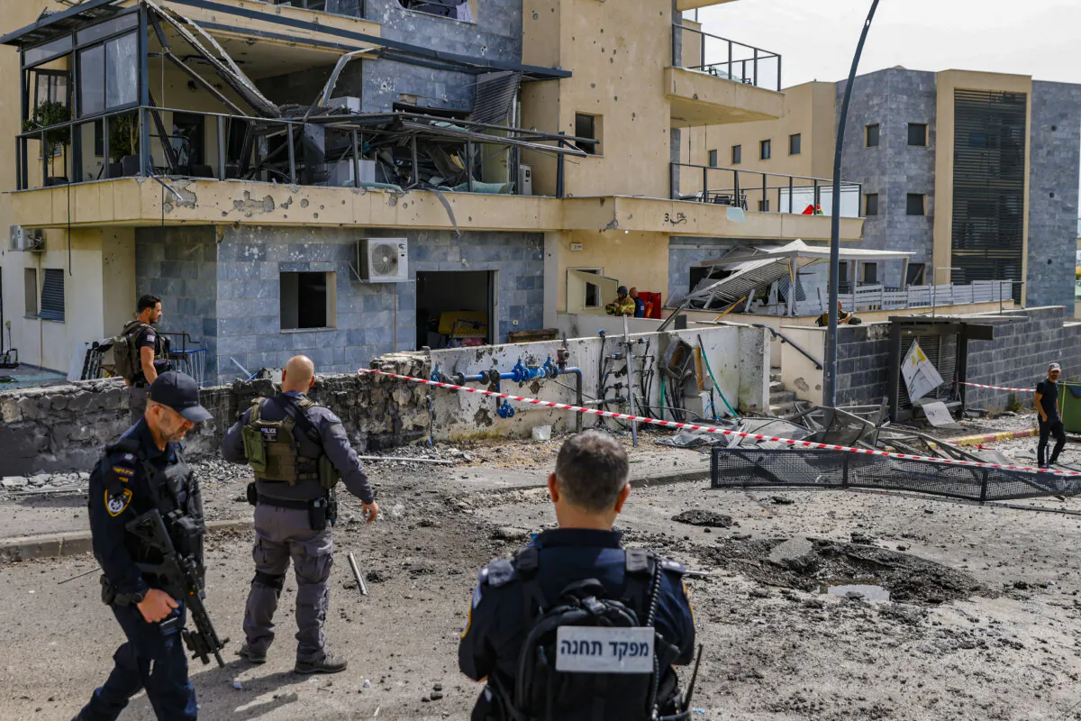 Israeli forces check a building that was hit by a Hezbollah rocket in Kiryat Shmona in northern Israel near the Lebanon border, on March 27, 2024. (JALAA MAREY/AFP via Getty Images)
