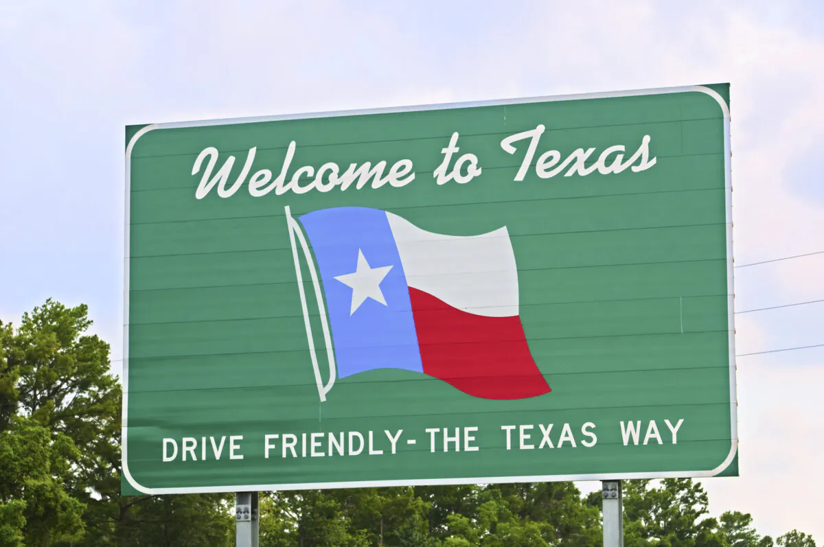 Texas welcome sign coming from the east on Interstate 10 with colored clouds