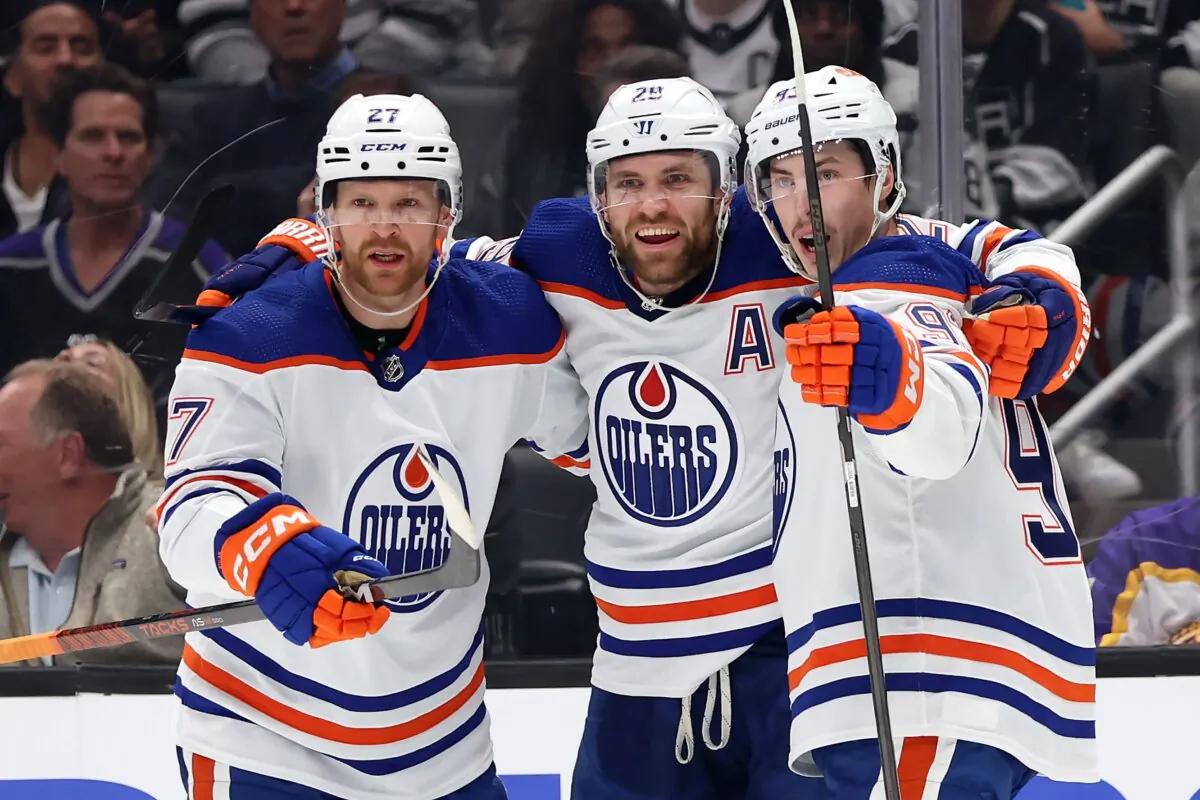 Ryan Nugent-Hopkins (93), and Brett Kulak (27) congratulate Leon Draisaitl (29) of the Edmonton Oilers after his goal during the first period of Game Three of the First Round of the 2024 Stanley Cup Playoffs against the Los Angeles Kings in Los Angeles on April 26, 2024. (Sean M. Haffey/Getty Images)