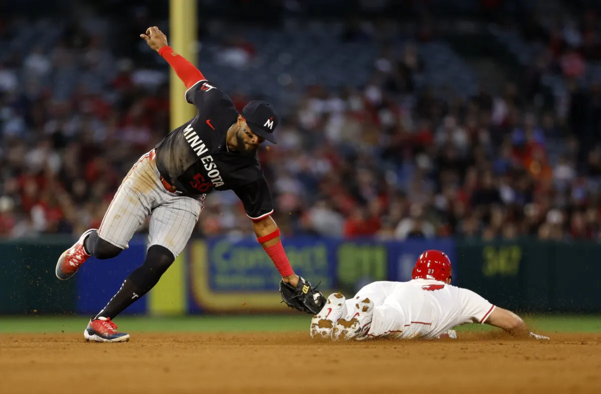 Willi Castro (50) of the Minnesota Twins tags out Mike Trout (27) of the Los Angeles Angels at second base as he attempts to steal during the fourth inning  in Anaheim, Calif., on April 26, 2024. (Kevork Djansezian/Getty Images)