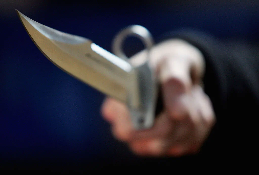 A hunting knife is held at a film and television prop company in London. (Ian Waldie/Getty Images)