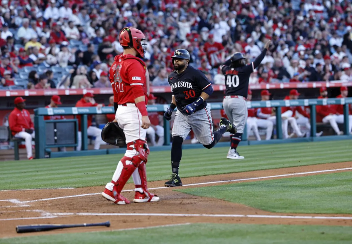 Carlos Santana (30) of the Minnesota Twins scores a run against catcher Matt Thaiss (21) of the Los Angeles Angels during the second inning in Anaheim, Calif., of Anaheim on April 27, 2024. (Kevork Djansezian/Getty Images)