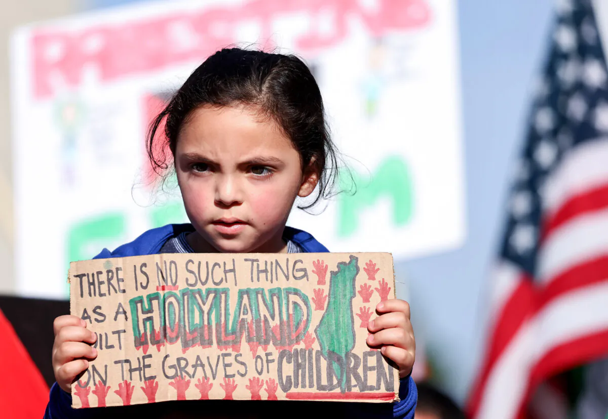 A young demonstrator holds an anti-Israel sign in a file image in Los Angeles on Dec. 2, 2023. (Mario Tama/Getty Images)