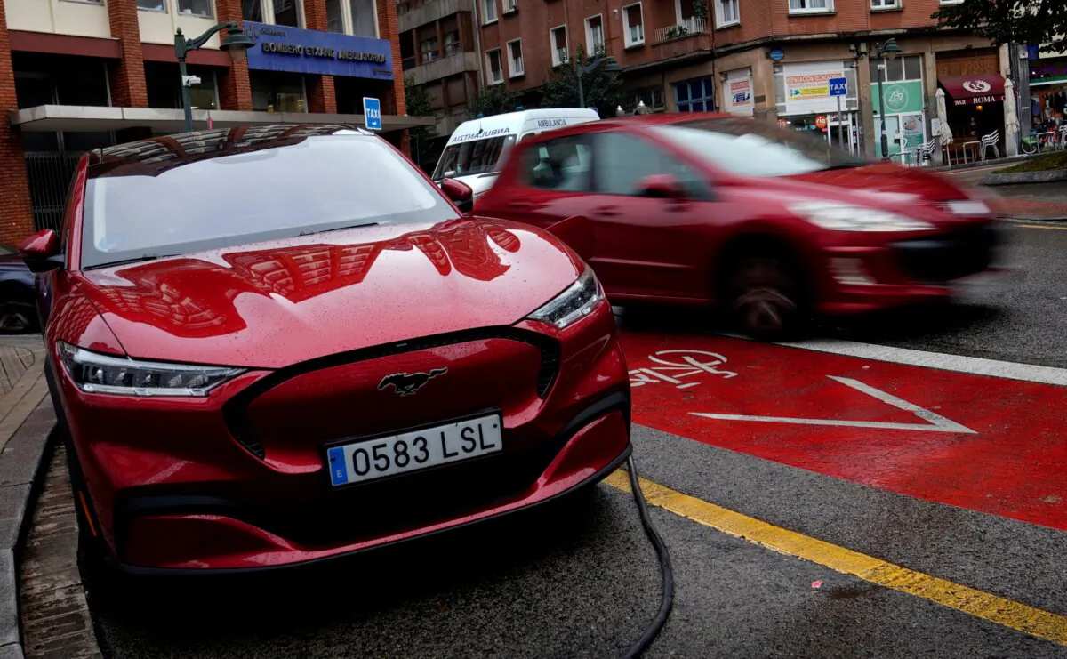 A Ford Mustang Mach-e electric vehicle plugged into a charging station in Bilbao, Spain, on Nov. 10, 2023. (Vincent West/Reuters)