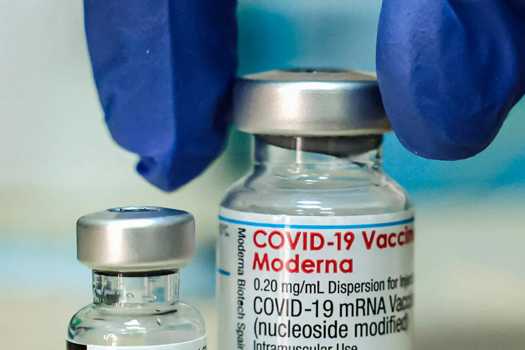 A medic prepares two vials of COVID-19 vaccines. (Hazem Bader/AFP via Getty Images)