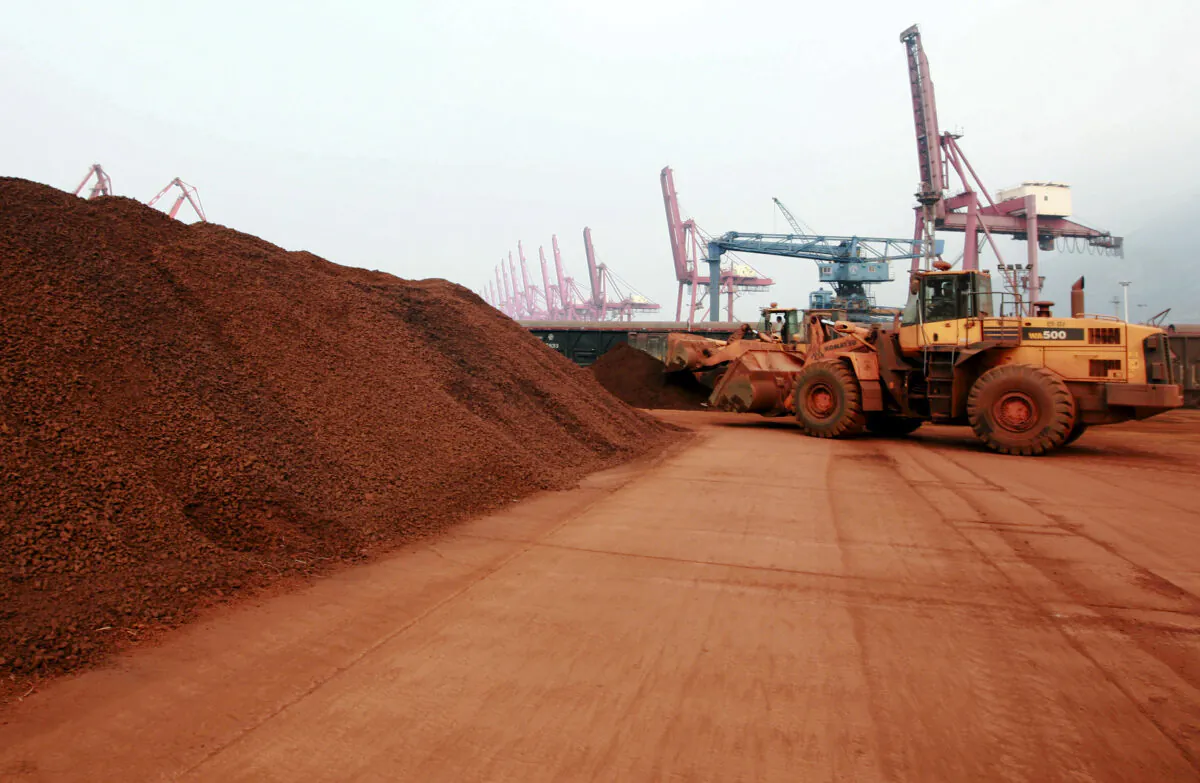 A loader shifts soil containing rare earth minerals to be loaded at a port in Lianyungang, Jiangsu Province, China, for export to Japan, on Sept. 5, 2010. (STR/AFP via Getty Images)