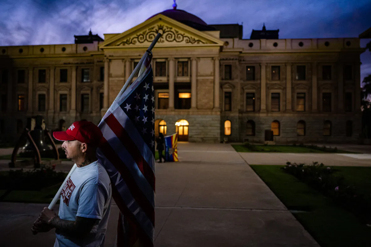 A supporter of Kari Lake stands in protest at the Arizona State Capitol Building in Phoenix, Ariz., on Nov. 15, 2022. (Jon Cherry/Getty Images)