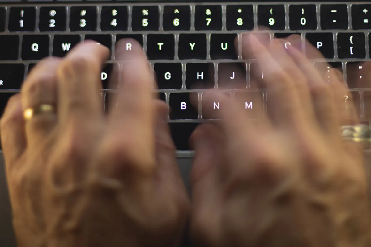 A man uses a computer keyboard in Toronto on Oct. 9, 2023. (The Canadian Press/Graeme Roy)