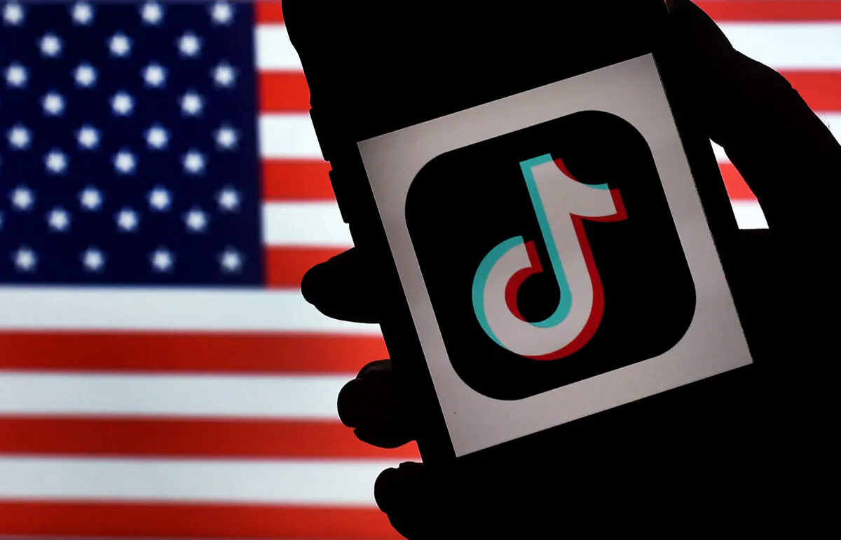 In this photo illustration, the social media application logo, TikTok is displayed on the screen of an iPhone on an American flag background in Arlington, Va., on Aug. 3, 2020. (Olivier Douliery/ AFP via Getty Images)