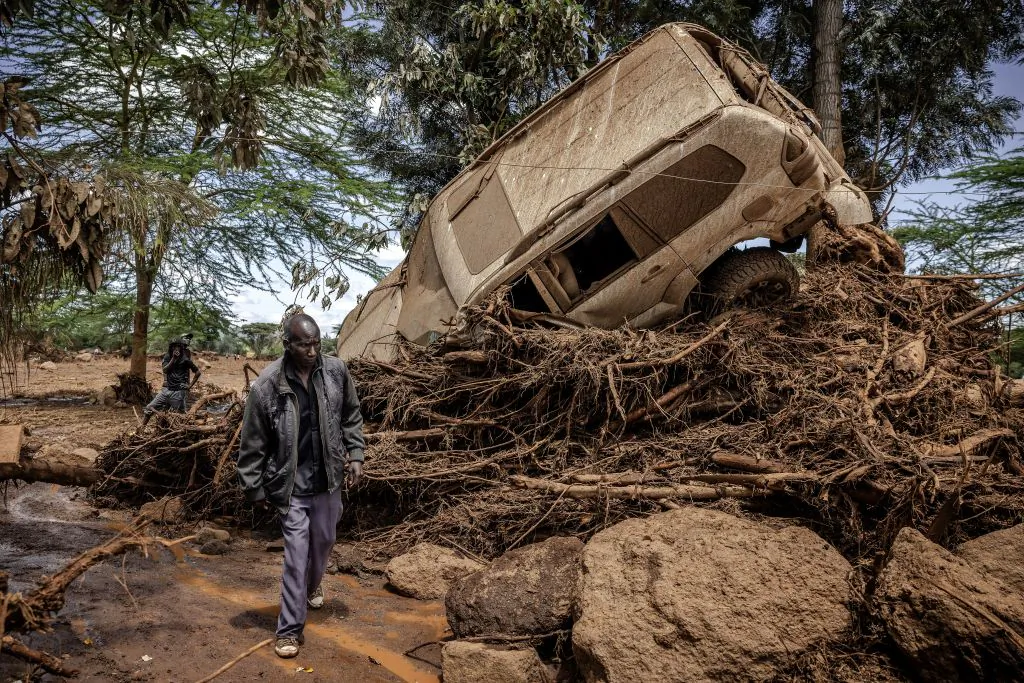 A man walks next to a damaged car in an area heavily affected by torrential rains and flash floods in the village of Kamuchiri, near Mai Mahiu, in Kenya on April 29, 2024. 

(LUIS TATO/AFP via Getty Images)