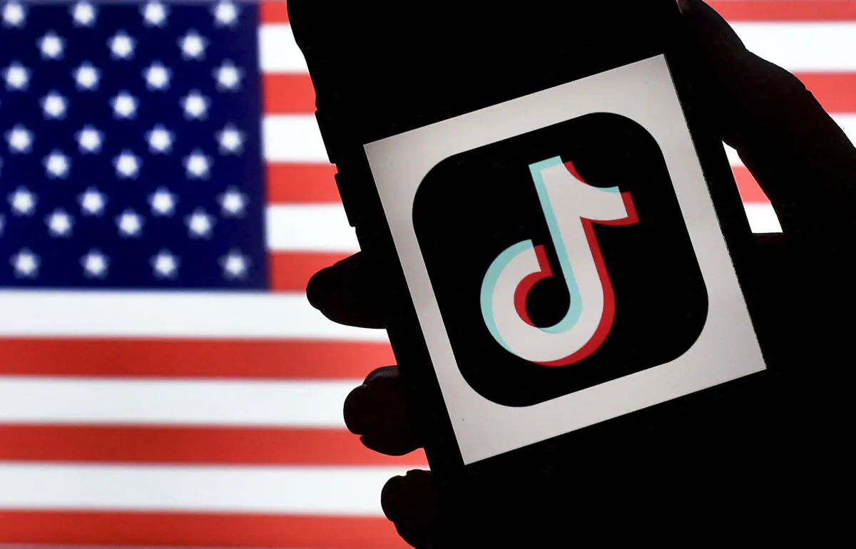 The logo of social media app TikTok is displayed on the screen of an iPhone on a U.S. flag background in Arlington, Va., on Aug. 3, 2020. (Olivier Douliery/AFP via Getty Images)