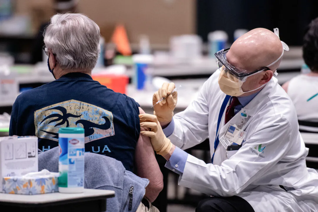 A man received a dose of the Pfizer COVID-19 vaccine at the Amazon Meeting Center in downtown Seattle, on Jan. 24, 2021. (Grant Hindsley/AFP via Getty Images)
