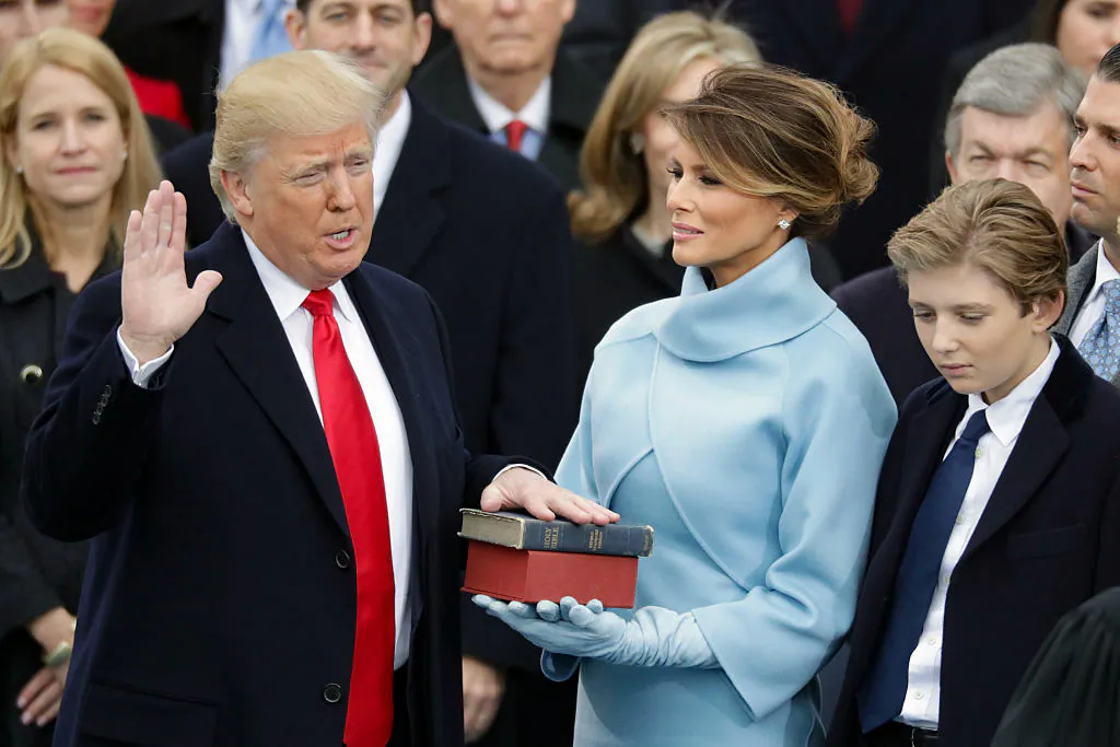 President Donald Trump (L) takes the oath of office as his wife Melania Trump (C) holds the bible and his son Barron Trump (R) looks on, on the West Front of the U.S. Capitol, on Jan. 20, 2017. (Chip Somodevilla/Getty Images)