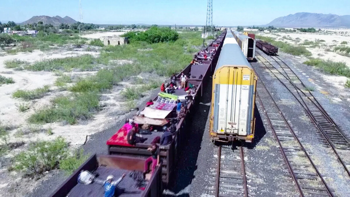 Immigrants ride on top of a cargo train crossing northeast Mexico on Sept. 21, 2023. (Reuters/Screenshot via NTD)