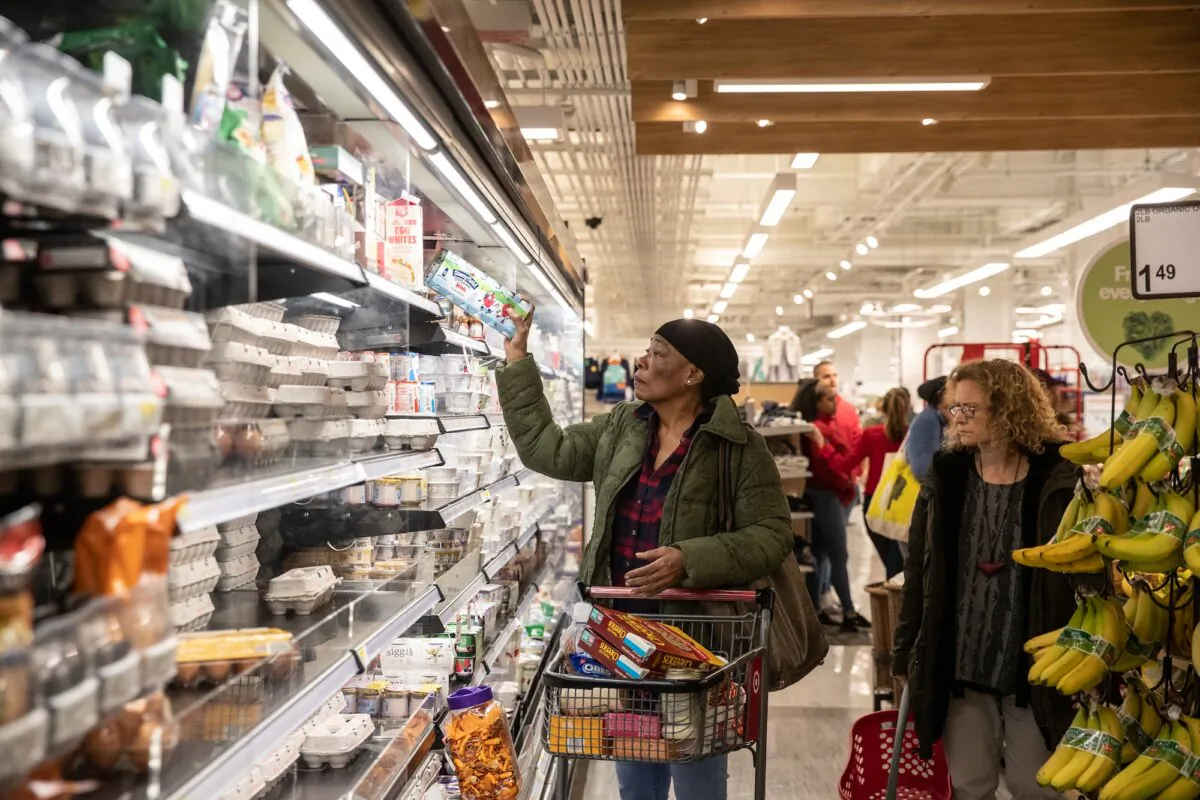 A customer picks up a dairy product at a store in New York City on March 13, 2020. (Jeenah Moon/Getty Images)