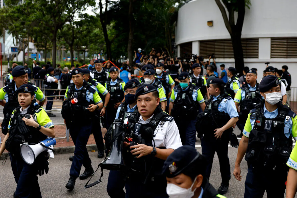 Police stand guard outside the West Kowloon Magistrates' Courts building during the verdict of the 47 pro-democracy activists charged under the national security law, in Hong Kong, on May 30, 2024. (Tyrone Siu/Reuters)