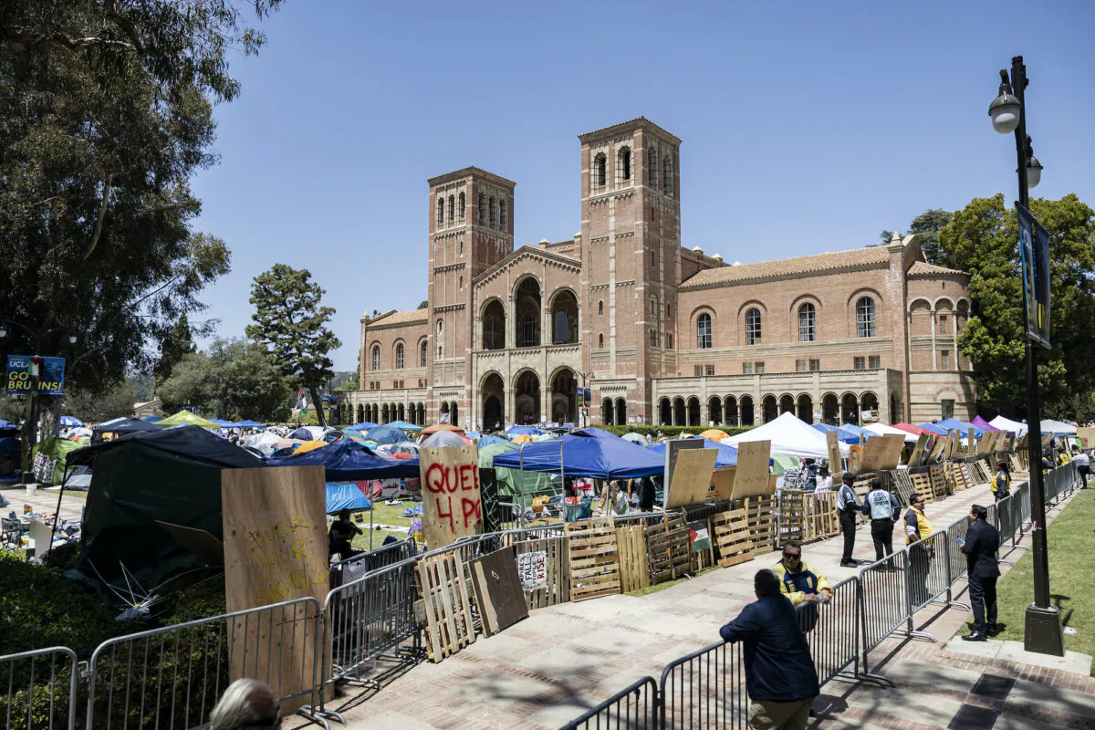 Pro-Palestinian protesters rebuild the barricade surrounding their encampment after clashes erupted overnight on the campus of the University of California Los Angeles (UCLA), in Los Angeles on May 1, 2024. (Etienne Laurent/AFP via Getty Images)