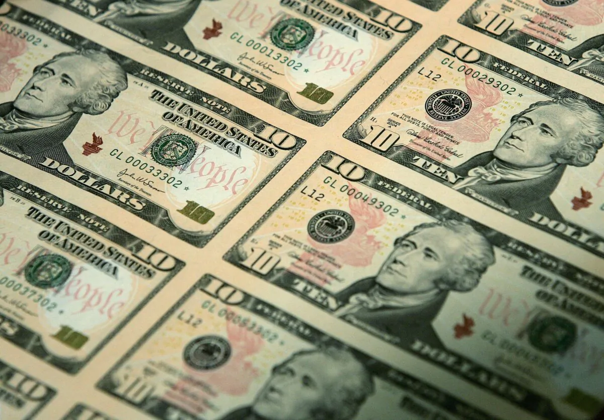 An uncut sheet of the redesigned US$10 bill after a news conference to commemorate the first day of circulation of the new notes at the National Archives in Washington, on March 2, 2006. (Alex Wong/Getty Images)
