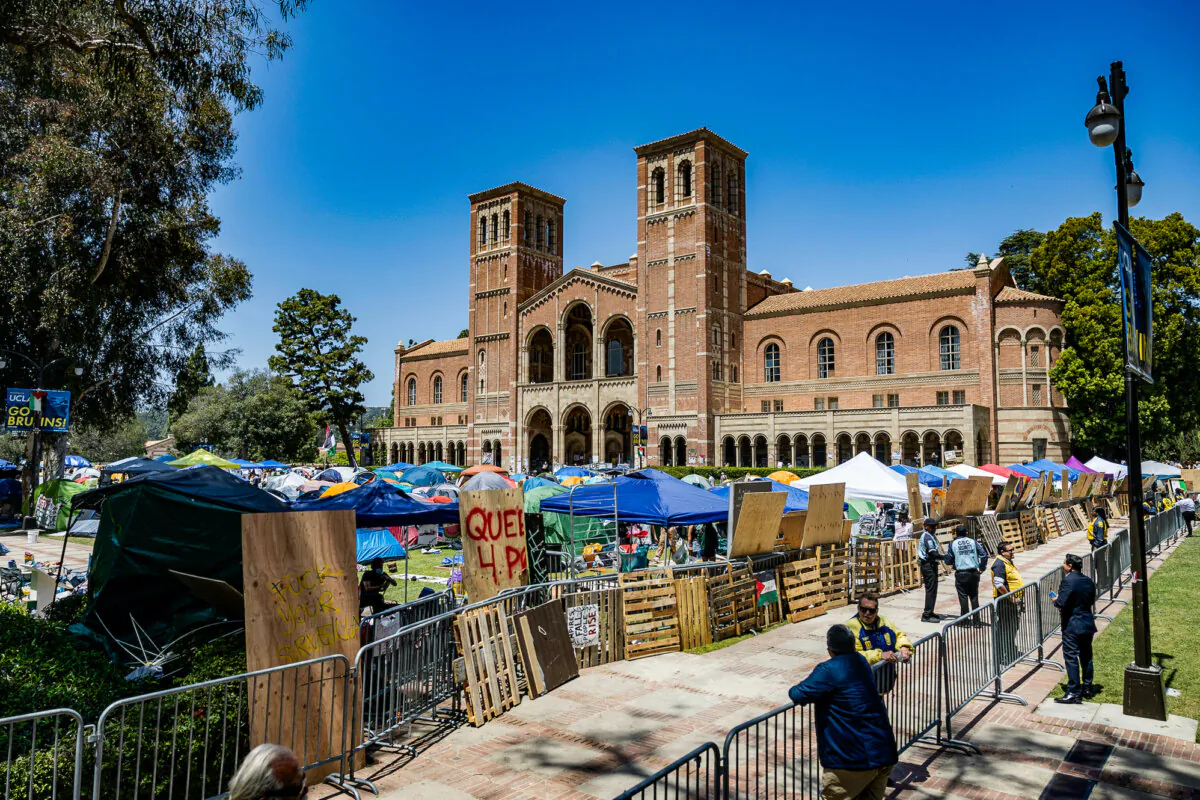 Pro-Palestinian protesters rebuild the barricade surrounding their encampment after clashes erupted overnight on the campus of the University of California Los Angeles (UCLA) on May 1, 2024. (Etienne Laurent/AFP via Getty Images)