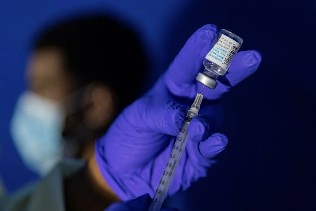 A family nurse practitioner prepares a syringe with the Mpox vaccine for inoculating a patient at a vaccination site in the Brooklyn borough of New York, on Aug. 30, 2022. (Jeenah Moon/AP Photo)