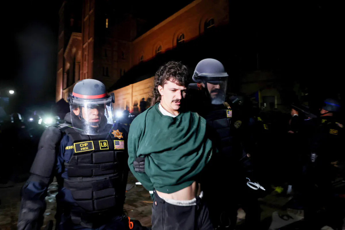 California Highway Patrol (CHP) officers detain a protestor while clearing a pro-Palestinian encampment after dispersal orders were given at the University of California, Los Angeles (UCLA) campus, on May 2, 2024. (Mario Tama/Getty Images)