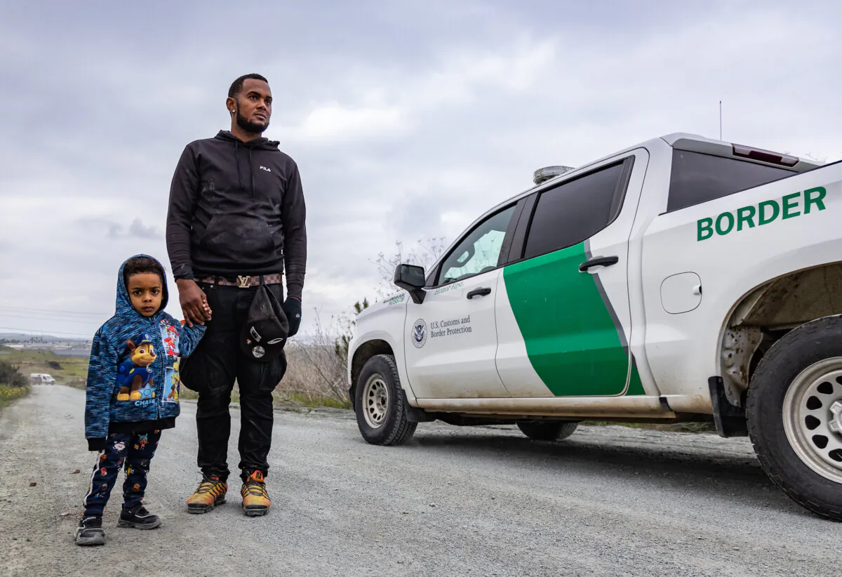 Border Patrol agents drive past illegal immigrants in Otay Mesa, Calif., on Feb. 29, 2024. (John Fredricks/The Epoch Times)