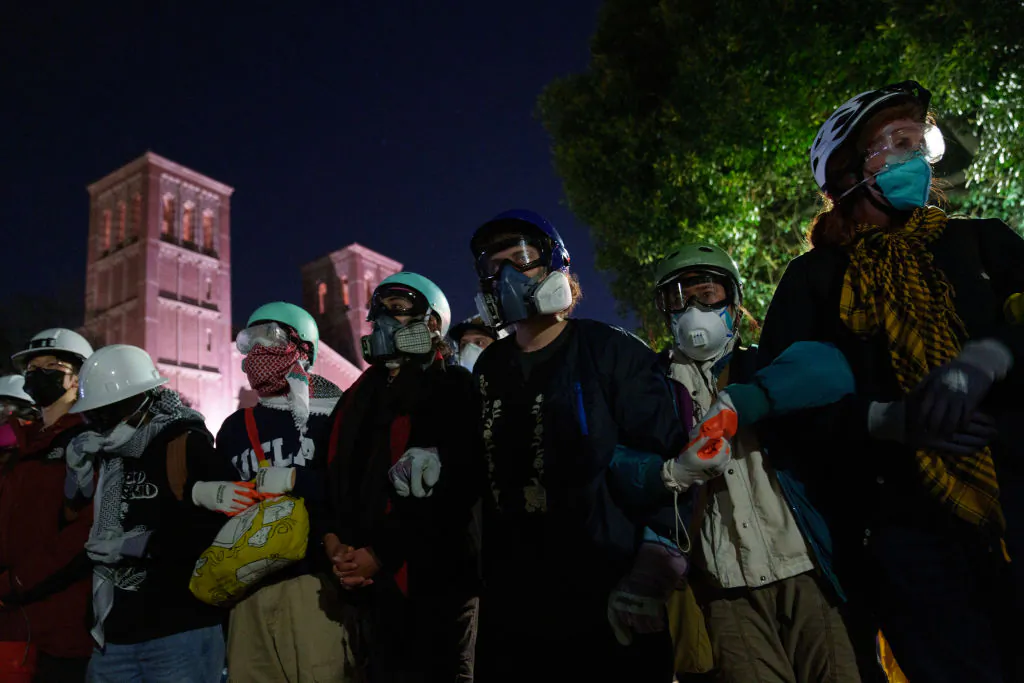 Pro-Palestinian protesters link arms as they face law enforcement in an encampment at UCLA in Los Angeles on May 2, 2024. (Eric Thayer/Getty Images)