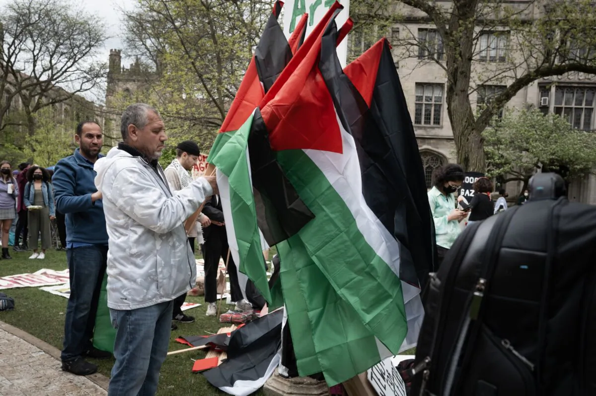 Palestinian flags are handed out on the campus of the University of Chicago where students have established a tent encampment to show support for Palestinians in Gaza, in Chicago, Ill., on April 29, 2024. (Scott Olson/Getty Images)