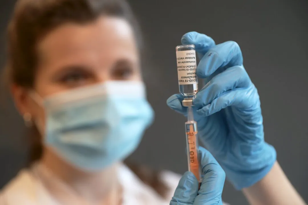 Clinical Pharmacist Ellie Morton prepares to administer the Oxford AstraZeneca COVID-19 vaccine at the community vaccination centre at Kingston University's Penrhyn Road campus in London on March 12, 2021. (Chris Jackson/Getty Images)