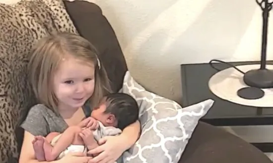 Little Girl Gets Emotional While Holding Baby Cousin
