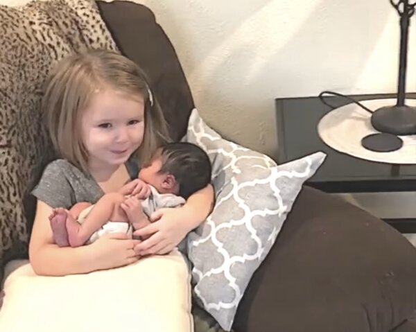 Little Girl Gets Emotional While Holding Baby Cousin