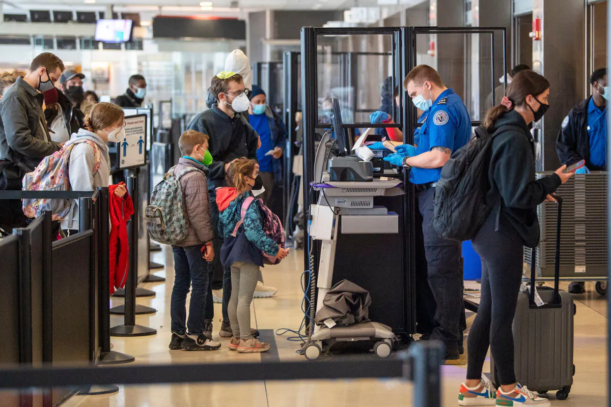 Travelers go through TSA security checkpoints at the Philadelphia International Airport on Dec. 21, 2021, in Philadelphia. (Jose F. Moreno/The Philadelphia Inquirer/TNS)