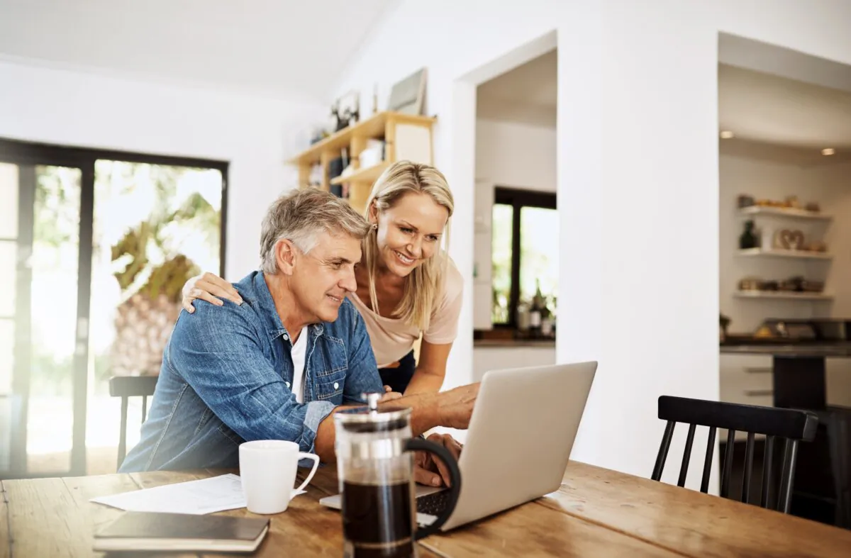 A couple plan their finances with a laptop in a photo file. (PeopleImages.com - Yuri A/Shutterstock)