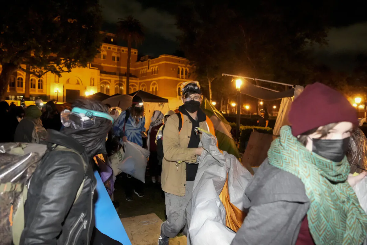 Pro-Palestinian demonstrators remove belongings from an encampment after police arrived on the campus at the University of Southern California in Los Angeles on May 5, 2024. (Ryan Sun/AP Photo)