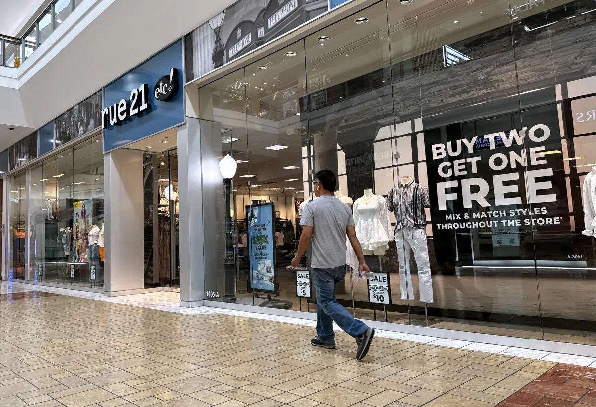 A shopper walks by a rue21 store at Solano Town Center in Fairfield, Calif., on May 3, 2024. Pittsburgh-based teen fashion retailer rue21 filed for Chapter 11 bankruptcy and plans to close all of its 540 stores in the coming weeks. (Justin Sullivan/Getty Images)