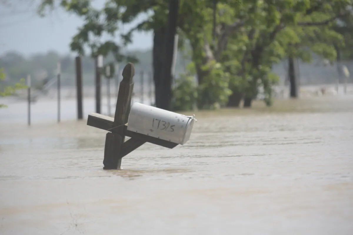A mailbox is partially submerged on a flooded street in an unincorporated area in east Harris County near Houston on Sunday morning, May 5, 2024. (AP Photo/Lekan Oyekanmi)